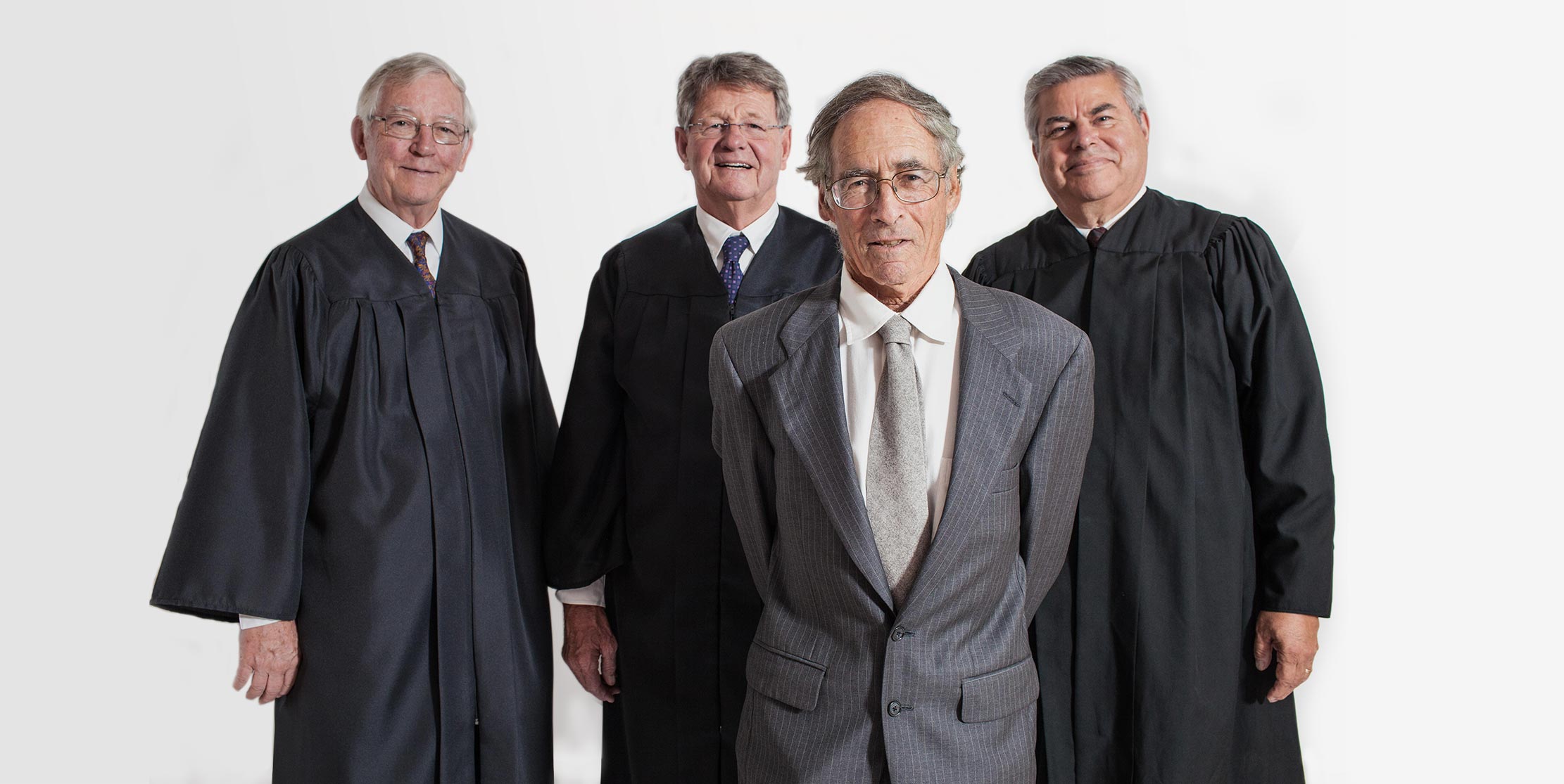 A group of men in suits and ties standing next to each other.